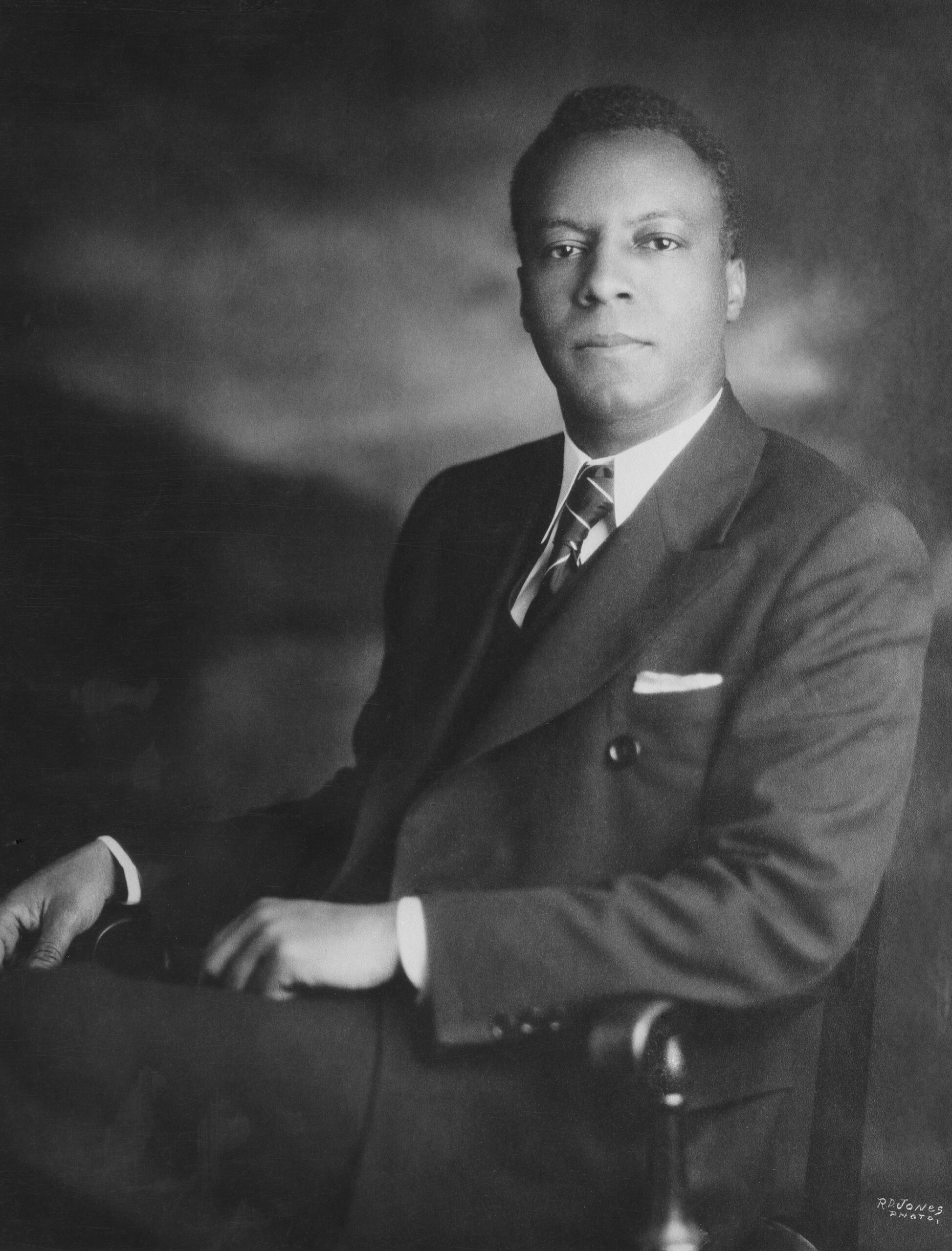 Seated black and white portrait of A. Philip Randolph