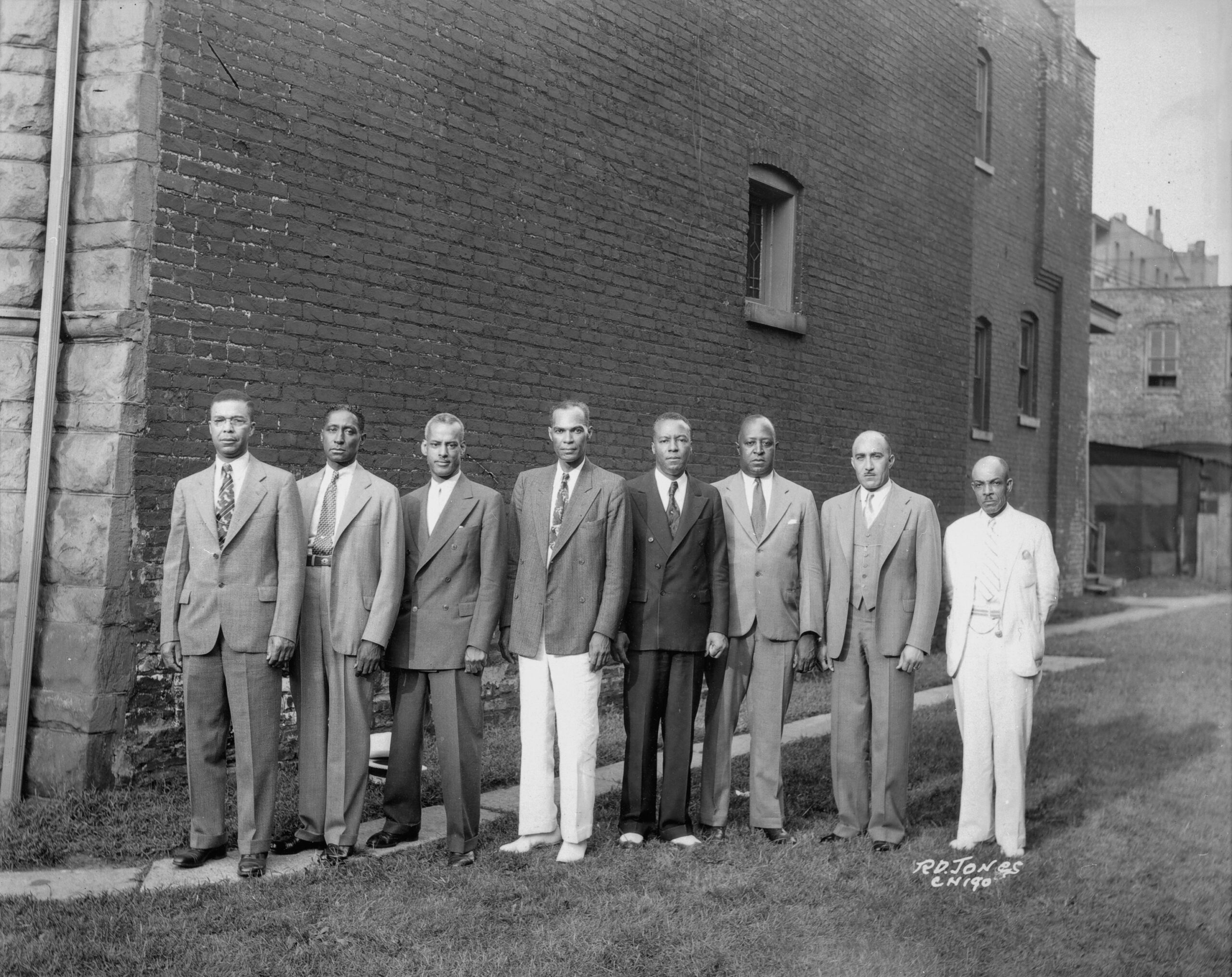 Photograph of eight officers of the Brotherhood of Sleeping Car Porters standing in a row