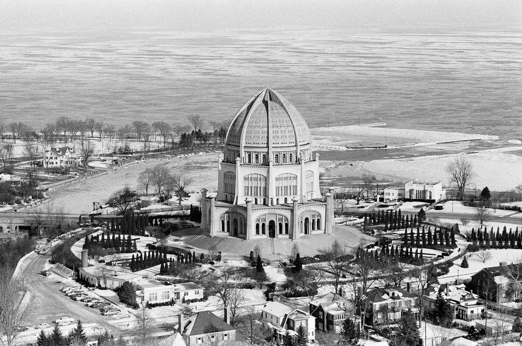 Aerial images of Chicago and its surrounding areas during winter. Locations include downtown Chicago, factories, frozen bodies of water, harbors, and the Baha'i House of Worship (Baha'i Temple), 100 Linden Avenue, Wilmette, Illinois.