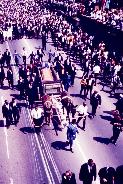 Mule-drawn cart carrying the casket of Dr. Martin Luther King Jr. leading the funeral procession from Ebenezer Baptist Church to Morehouse College, Atlanta, Georgia, April 9, 1968.