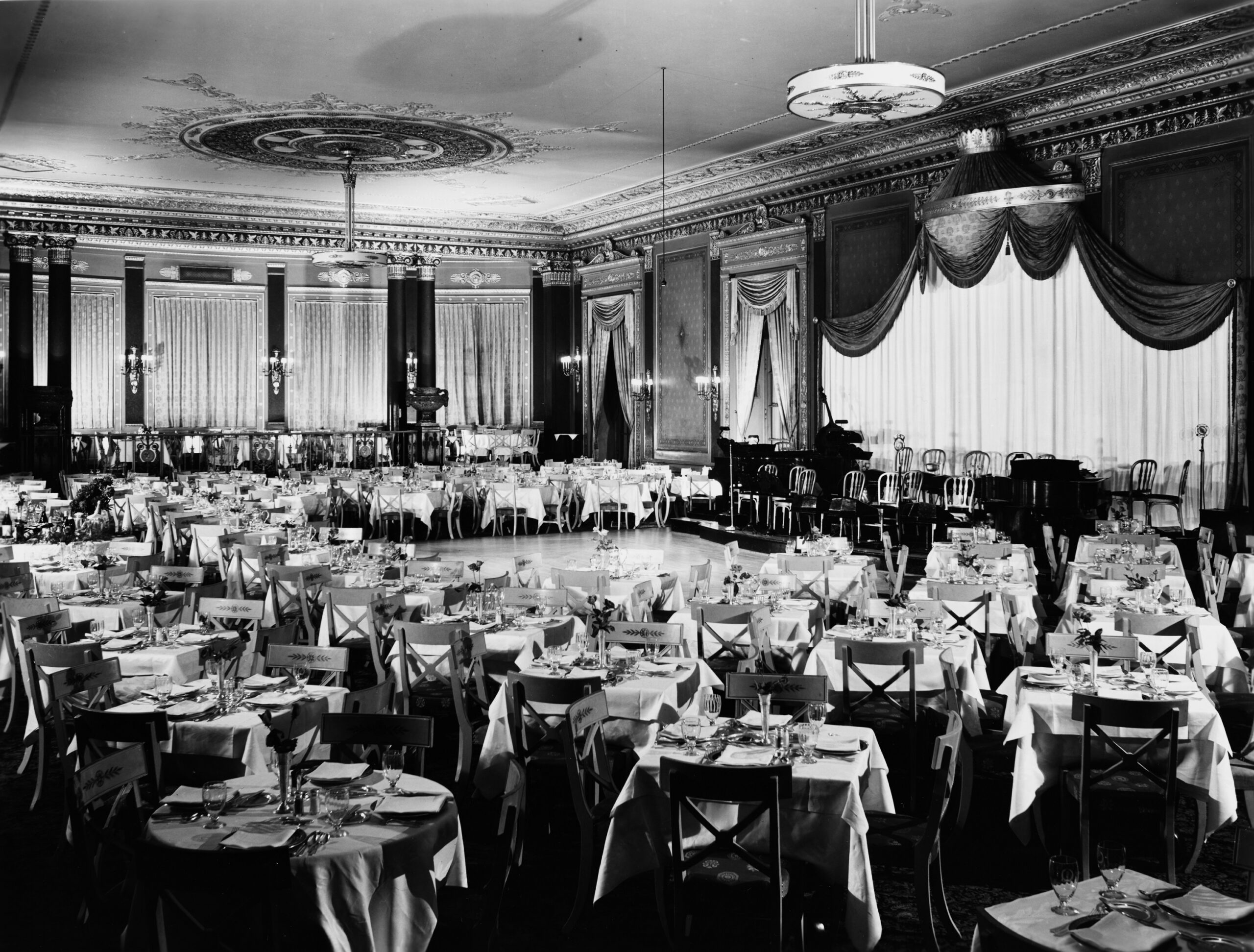 Interior view of the Empire Room, showing tables and chairs in correct positions, an event space inside the Palmer House hotel, in Chicago, Illinois, circa June 4-8, 1936.