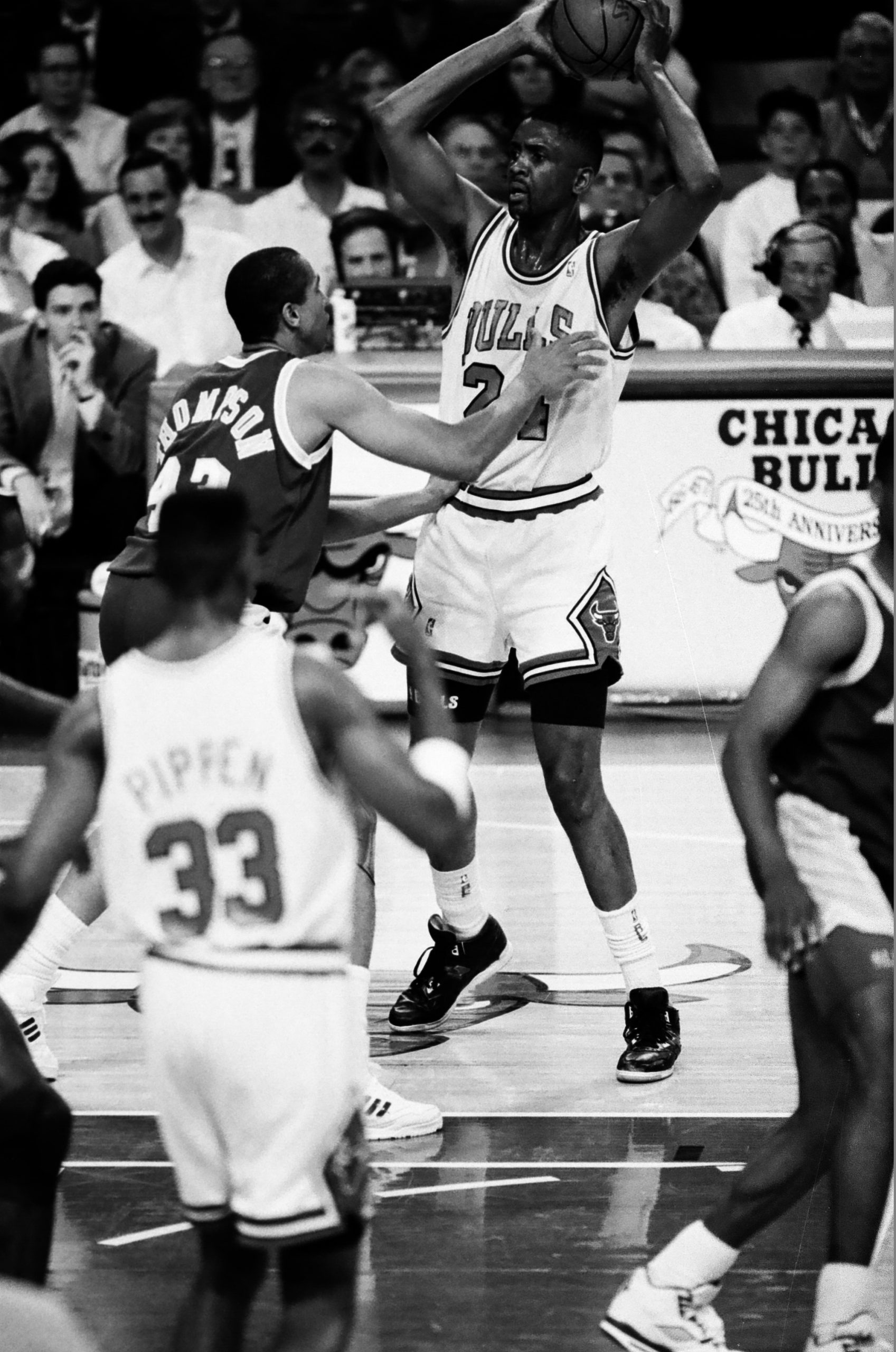 In the middle of a game Bill Cartwright is guarded with the ball looking to pass