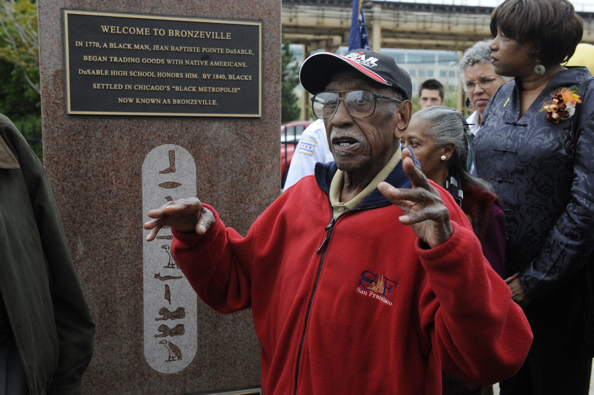 Two Bronzeville Obelisks are unveiled by the Bronzeville Merchants Assoc, a nine year project in the making. The 2 bronze obelisks, 6 feet tall by 3 feet weighting 4,000 pounds each and capture the rich cultural history from past to present of Bronzeville. Here, Prof Timuel D. Black, talks about the history of Bronzeville. Three Aldermen, Bronzeville Merchants Assoc together during the unveiling at 35th and State Street. (photo by john h white/chicago sun-times)