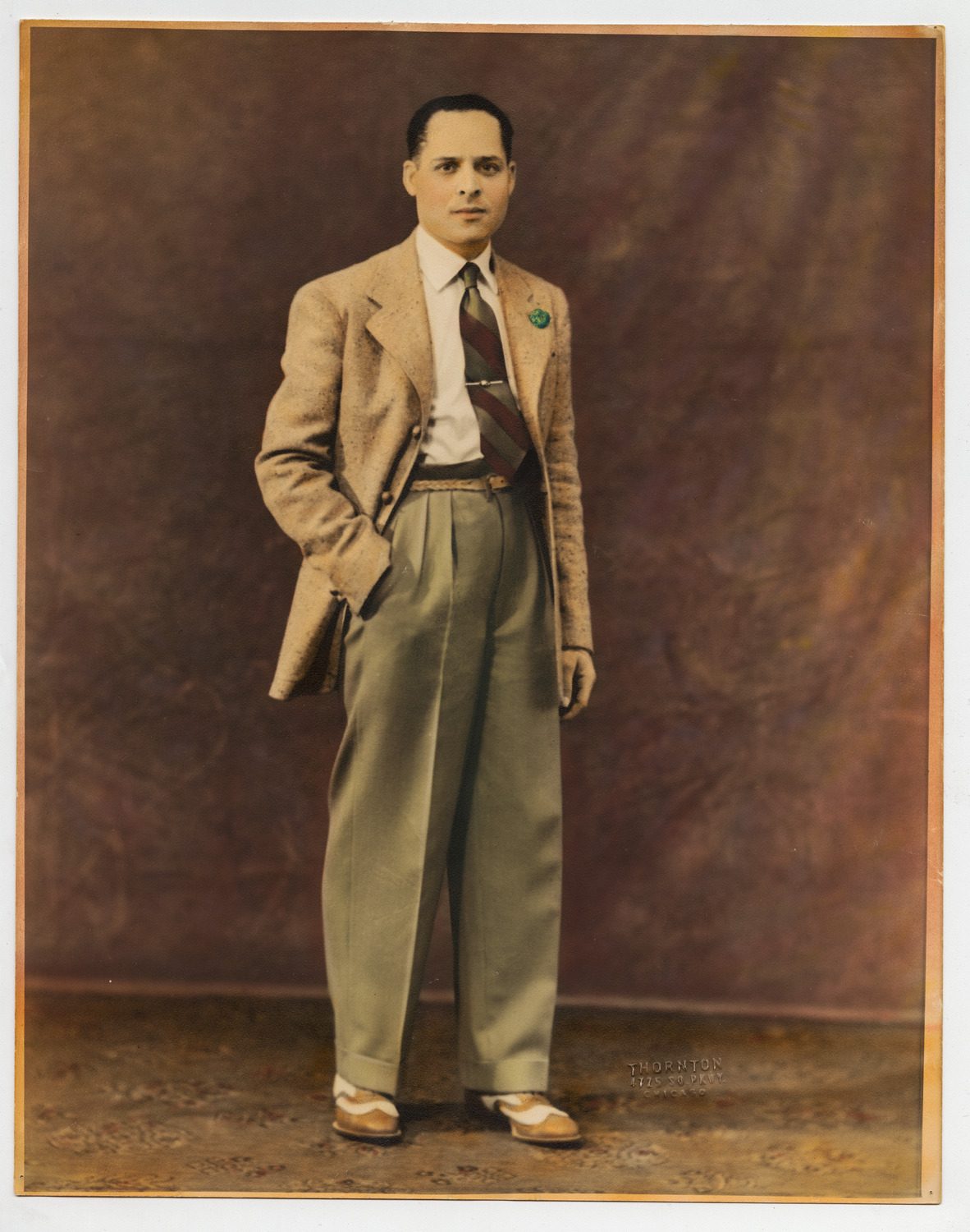 Hand-colored portrait of Scotty Piper dressed in a suit.