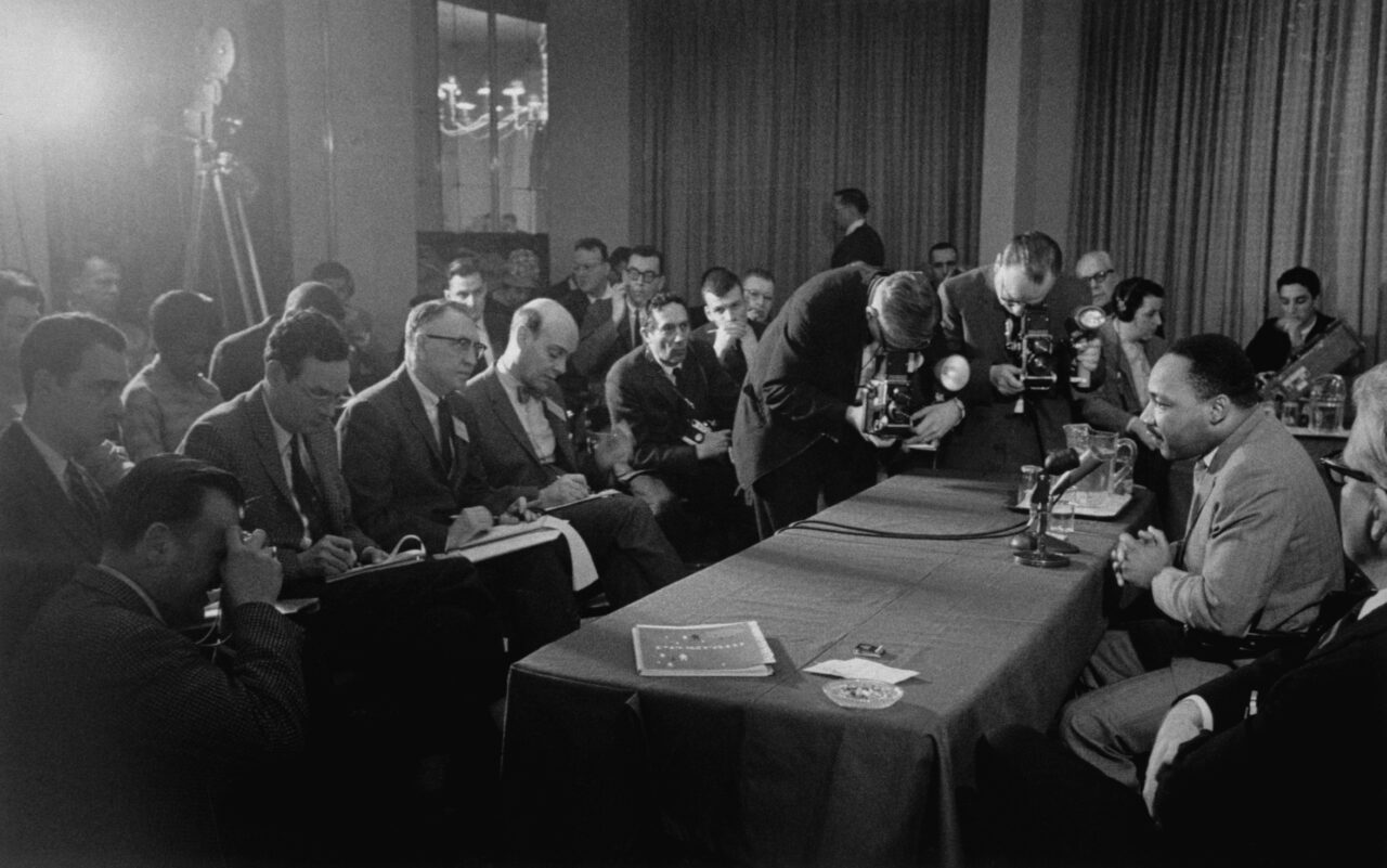 Martin Luther King Jr. speaking at a press conference