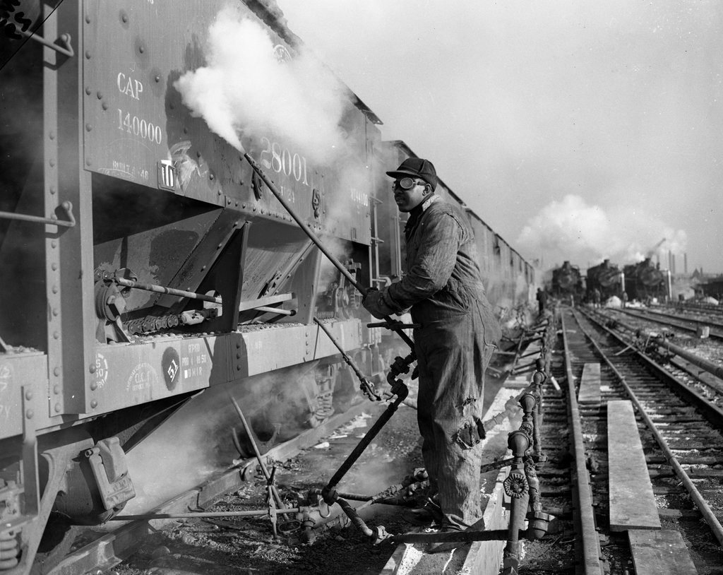 Worker thawing out frozen ore cars