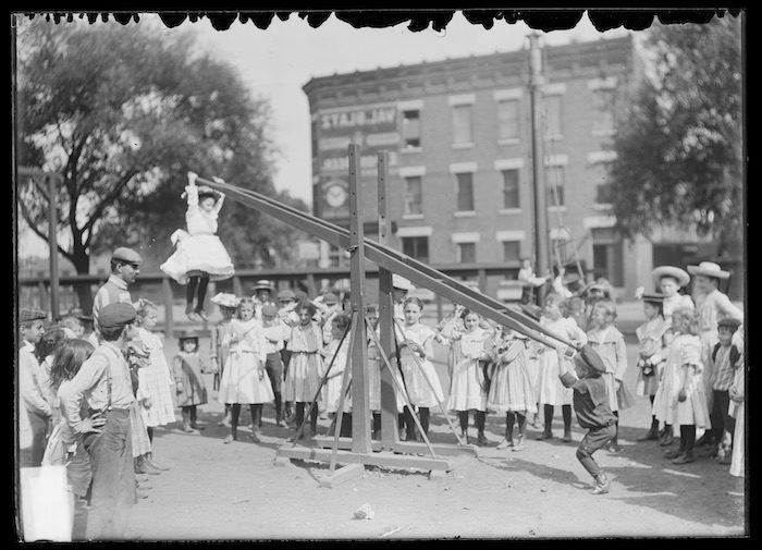 Children playing on a seesaw.