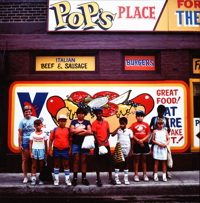 Group of children outside Pop’s Place hot dog stand.