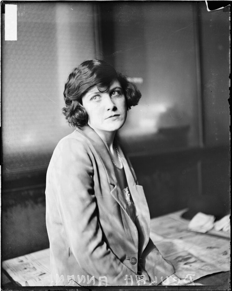 Half-length portrait of Beulah Annan, sitting with her head tilted to the left, looking away from the camera, in a room in Chicago