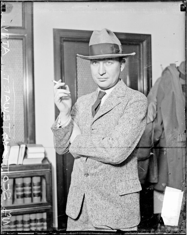 Three-quarter length portrait of attorney William Scott Stewart standing in a room in Chicago, Illinois, looking toward the camera.