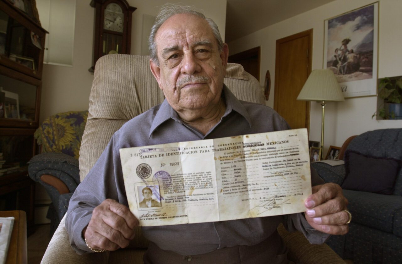 Felipe Nava holding a Mexican ID card
