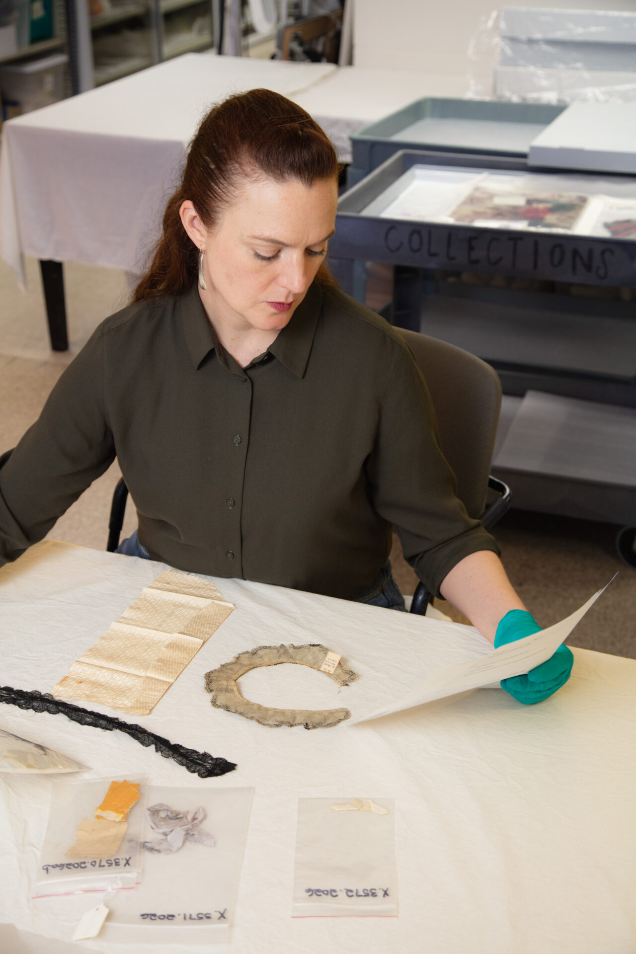 Collections Manager Jessica Pushor conducting research on objects for exhibition